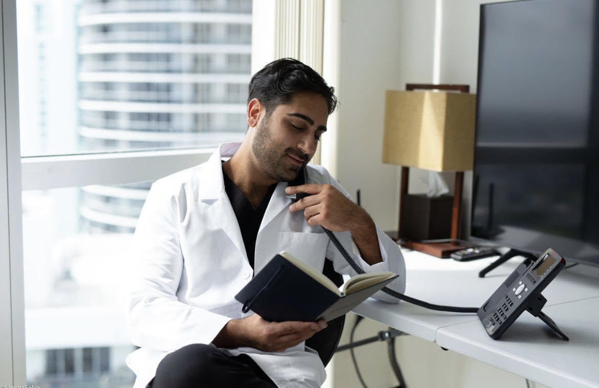 Dr. Allen reviewing patient notes at his desk