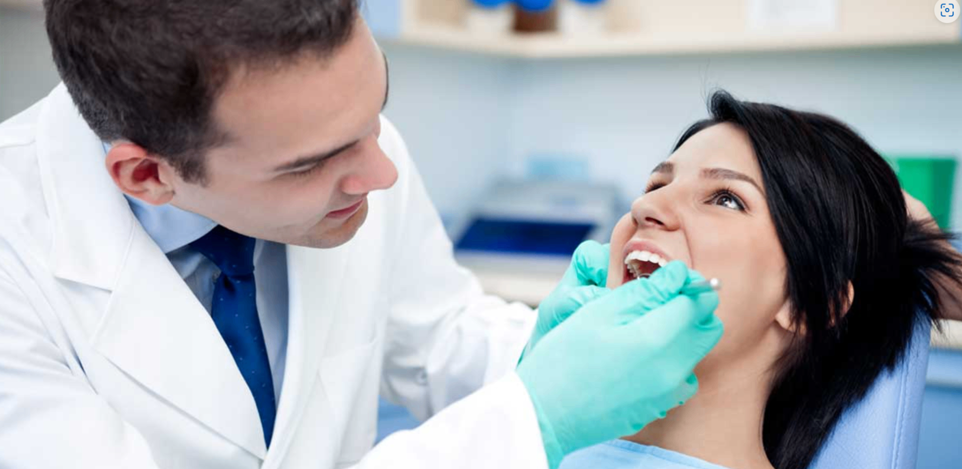 Dentist examining a patient's mouth during an oral cancer screening